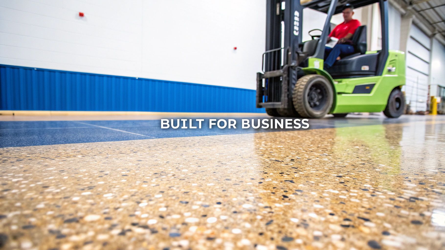 A forklift operates on a durable, two-toned polished concrete floor in a commercial setting.