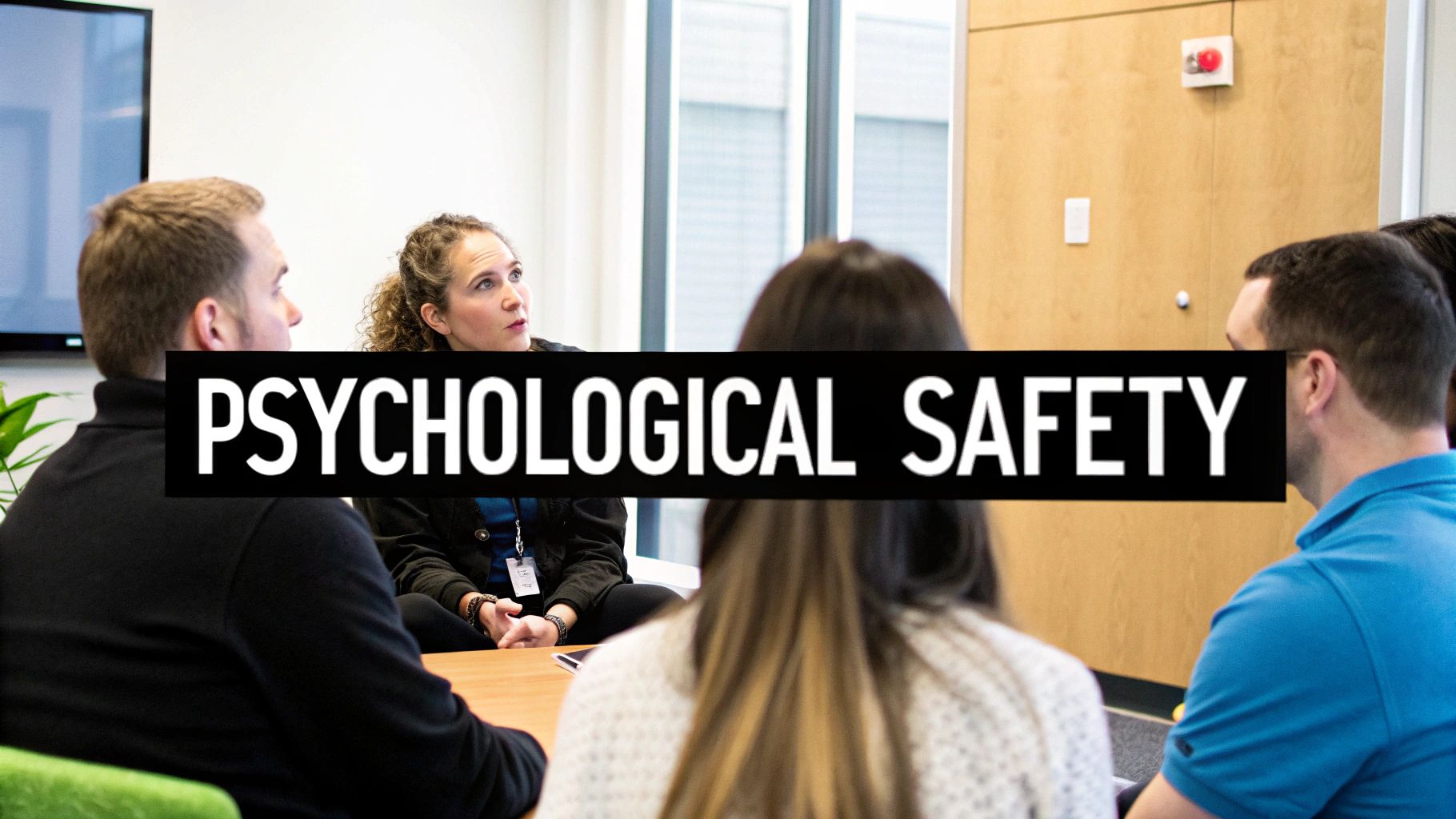 Diverse team members engage in a serious discussion about psychological safety in an office setting.