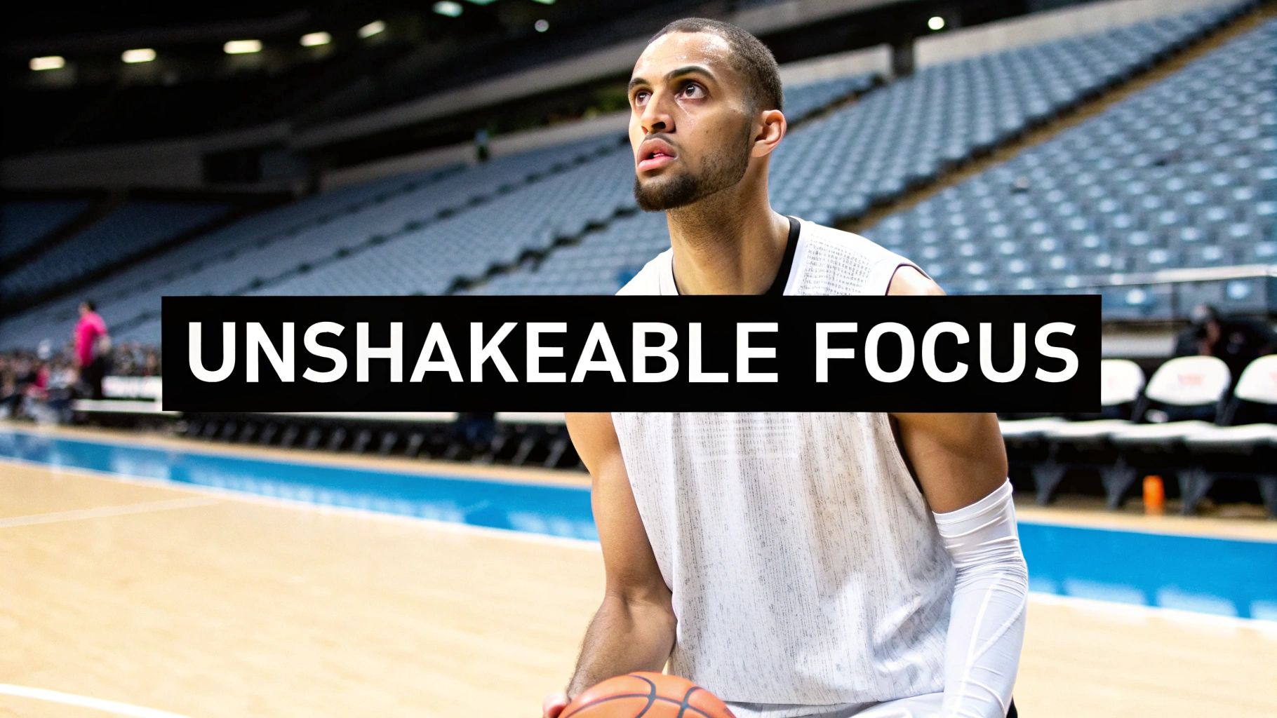 A focused male basketball player holds the ball on a court, representing unshakeable mental toughness.