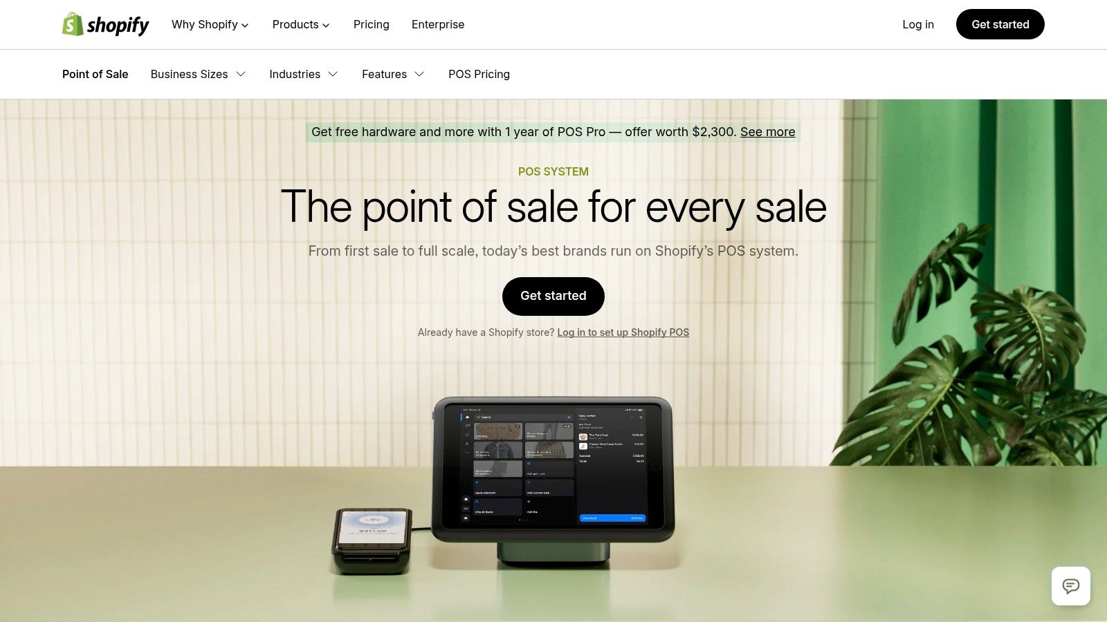 A retail employee using Shopify POS on a tablet to assist a customer.