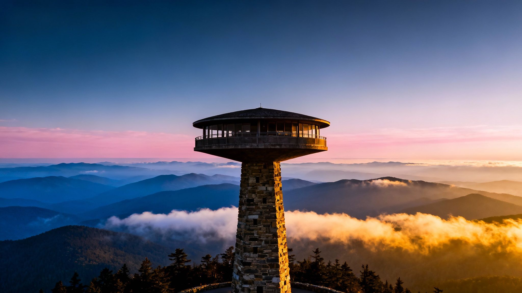 A scenic view of Clingmans Dome observation tower at sunrise with misty Great Smoky Mountains.