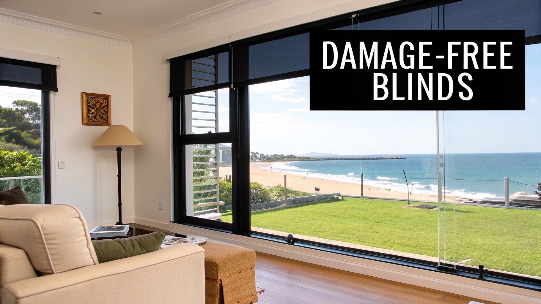 Modern living room with damage-free roller blinds overlooking ocean beach view through large black-framed windows