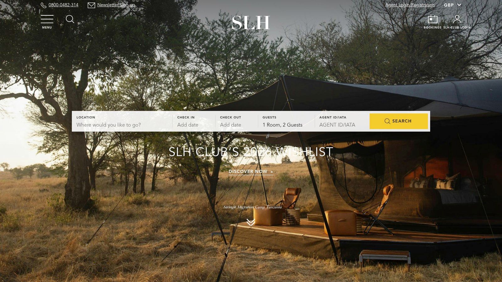 A dog sits outside a luxury safari-style tent, representing the unique, upscale pet-friendly stays available through SLH.