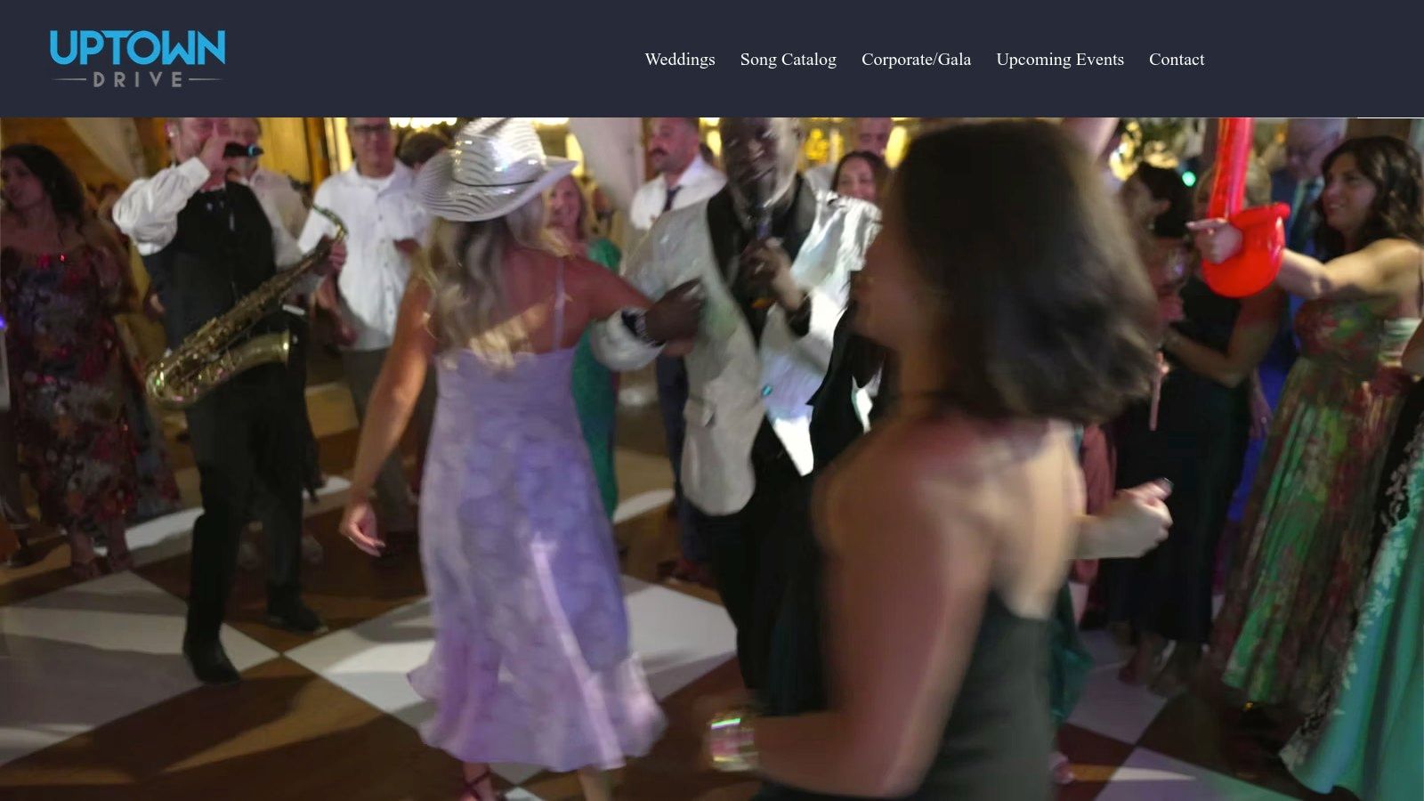 A full live band performing on stage with dramatic lighting at a corporate event.