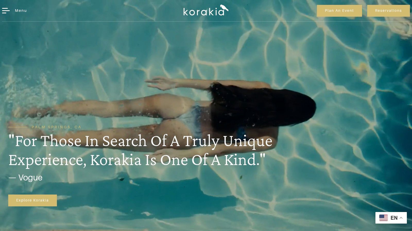A person swimming underwater in a clear blue pool at Korakia Pensione, Palm Springs.