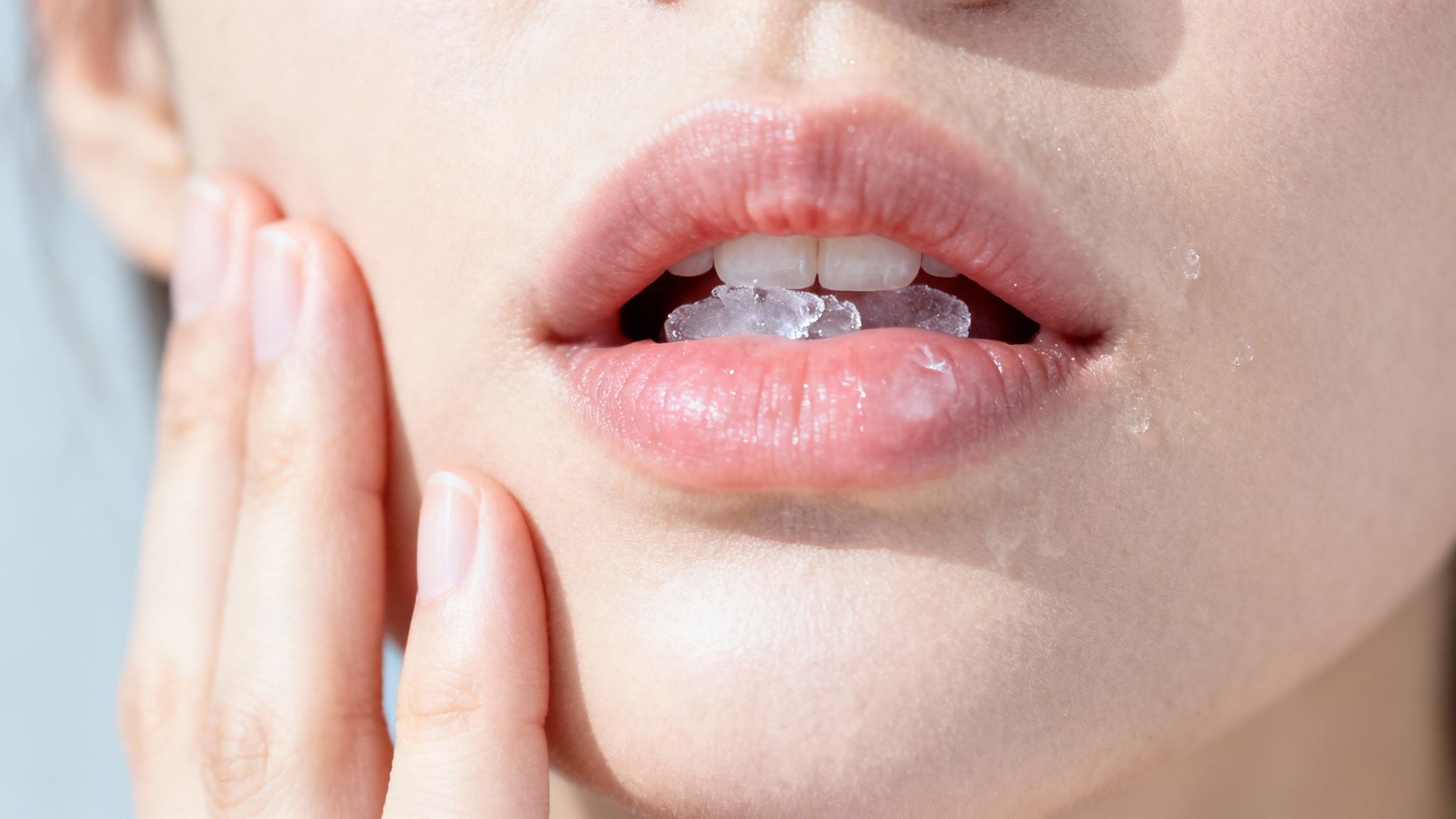 A person smiling, with a graphic overlay showing a slight 'zing' effect on one tooth to represent sensitivity.