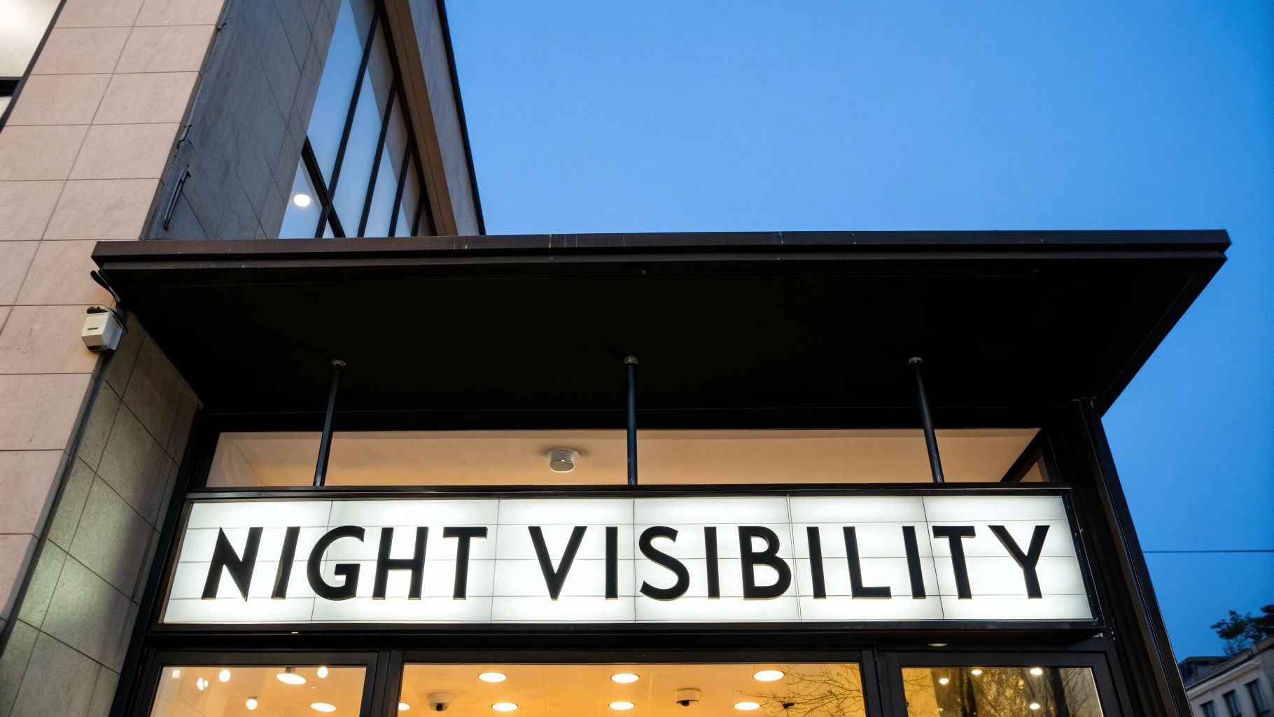 A brightly lit outdoor sign at night with clear, bold text.