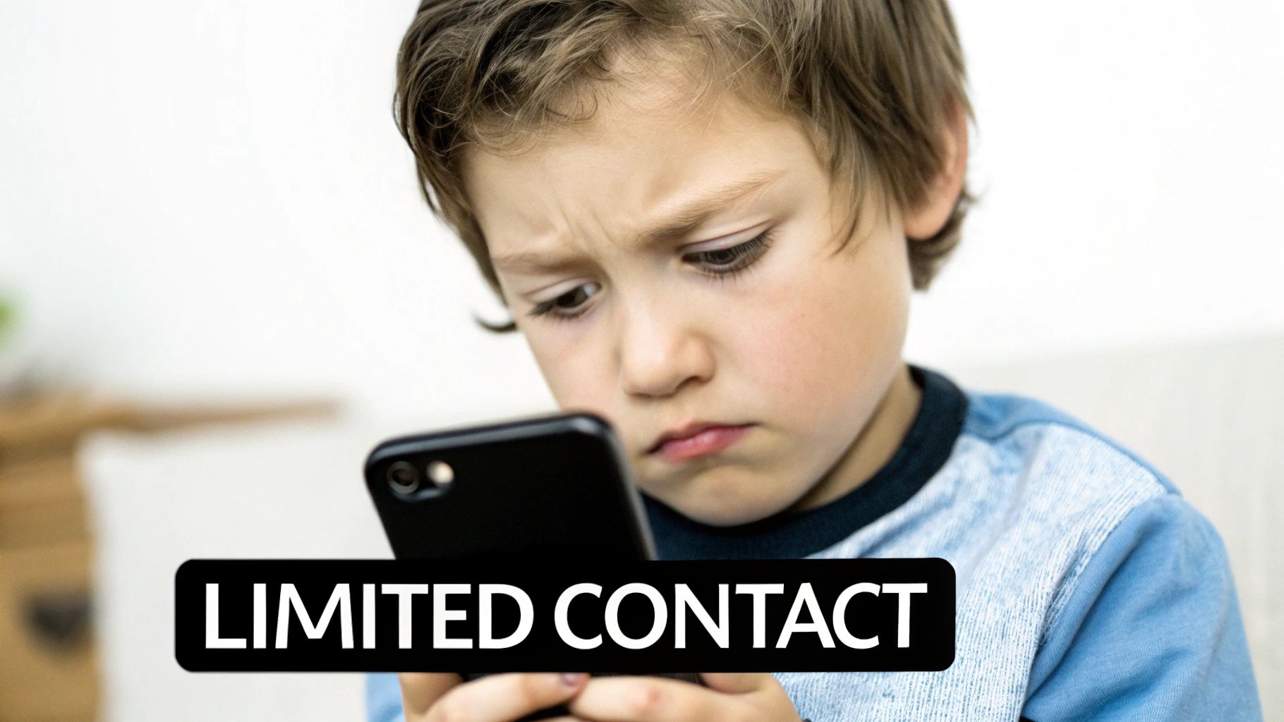 A young boy with a worried expression looks down at a smartphone, with 'LIMITED CONTACT' text.