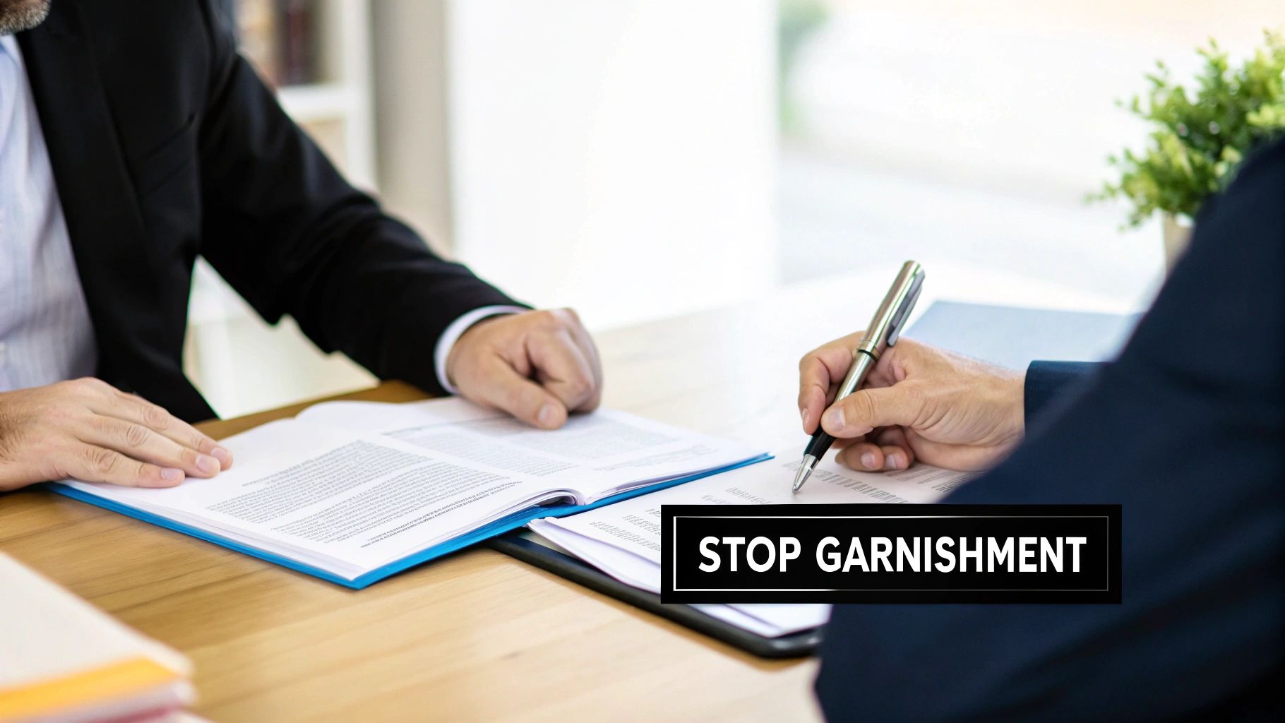 Two business professionals consult and sign legal documents at a wooden desk, featuring 'STOP GARNISHMENT' text overlay.