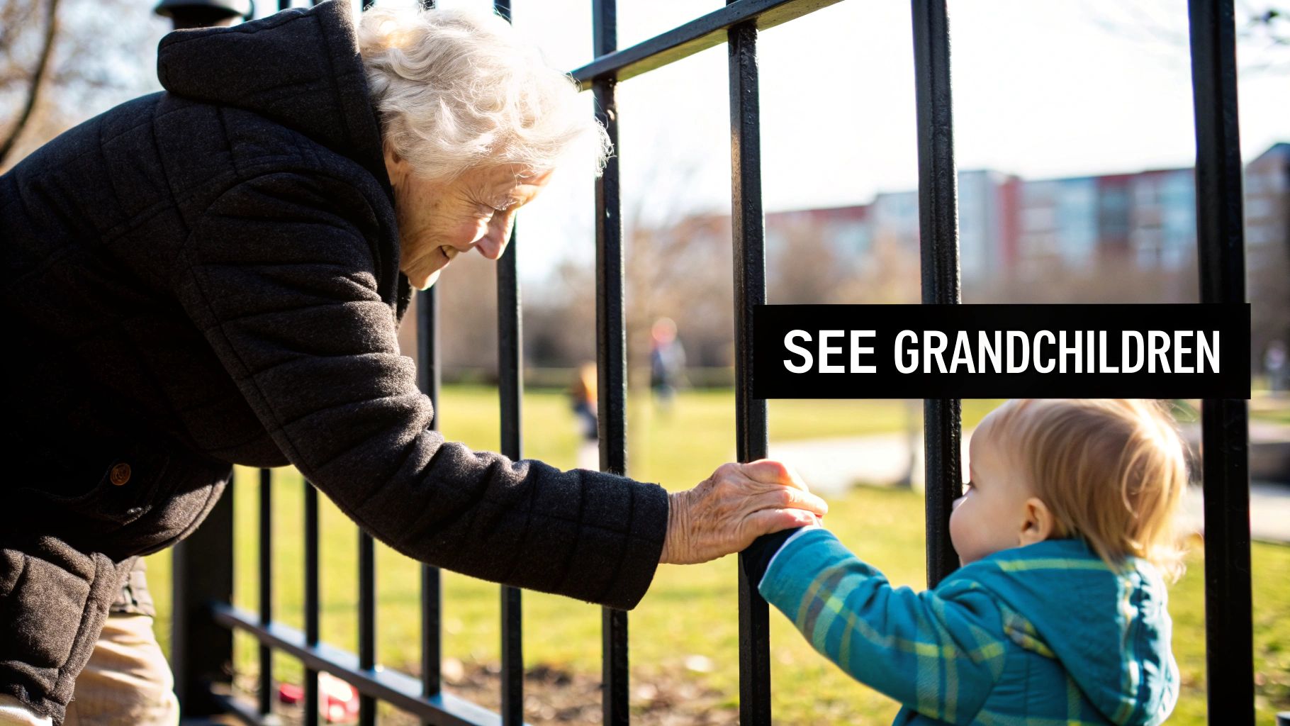 A grandparent holds the hand of their grandchild while walking outside.