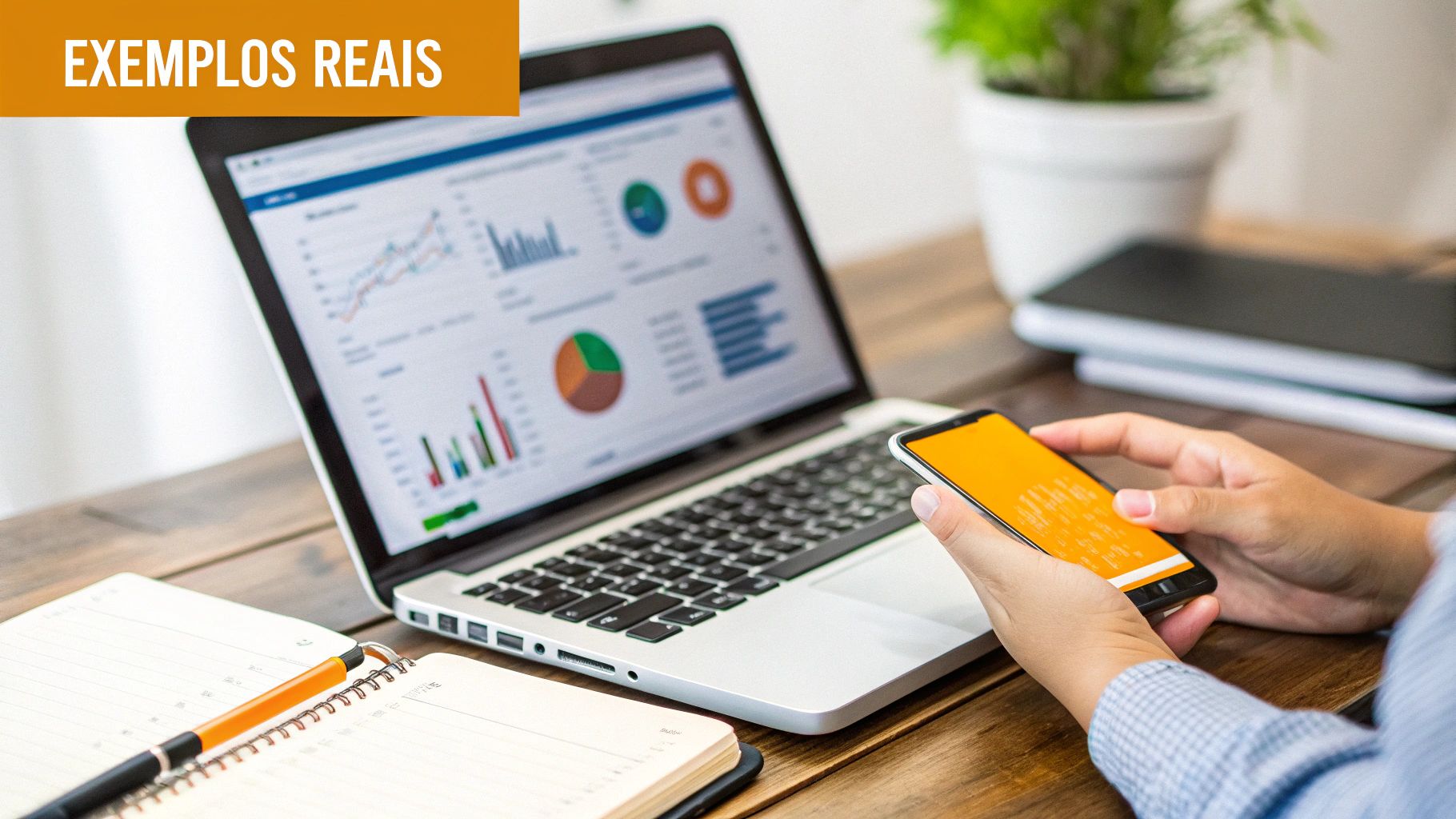 Pessoa analisando dados financeiros em laptop e smartphone, com gráficos e relatórios visíveis, em um ambiente de trabalho.