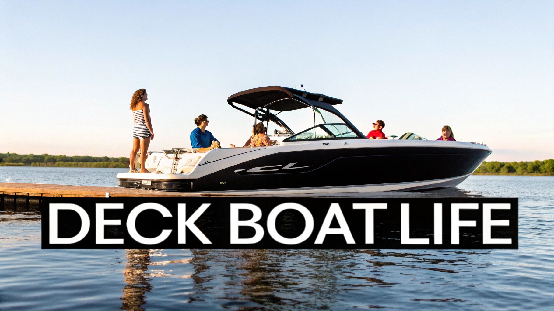 People enjoying a sunny day on a deck boat docked at a wooden pier on a calm lake.