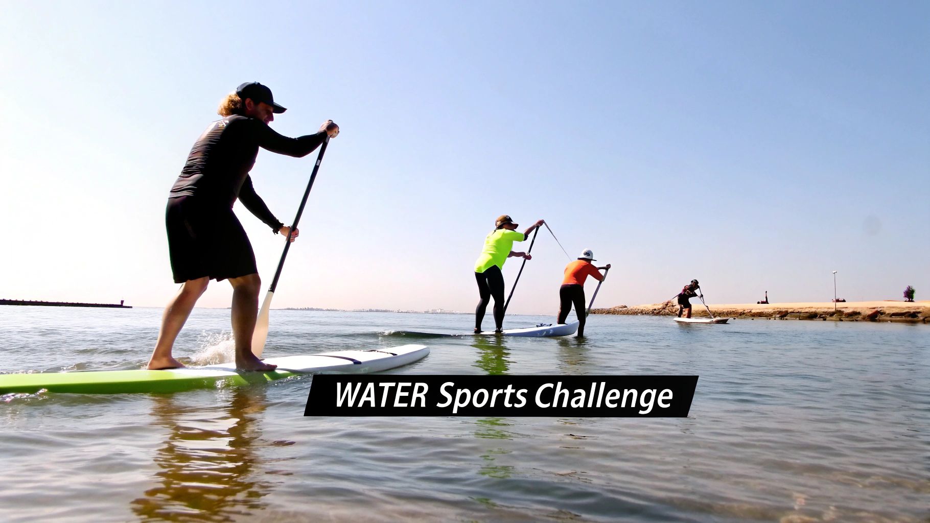 Several people paddleboard on calm water during a sunny "WATER Sports Challenge" event.