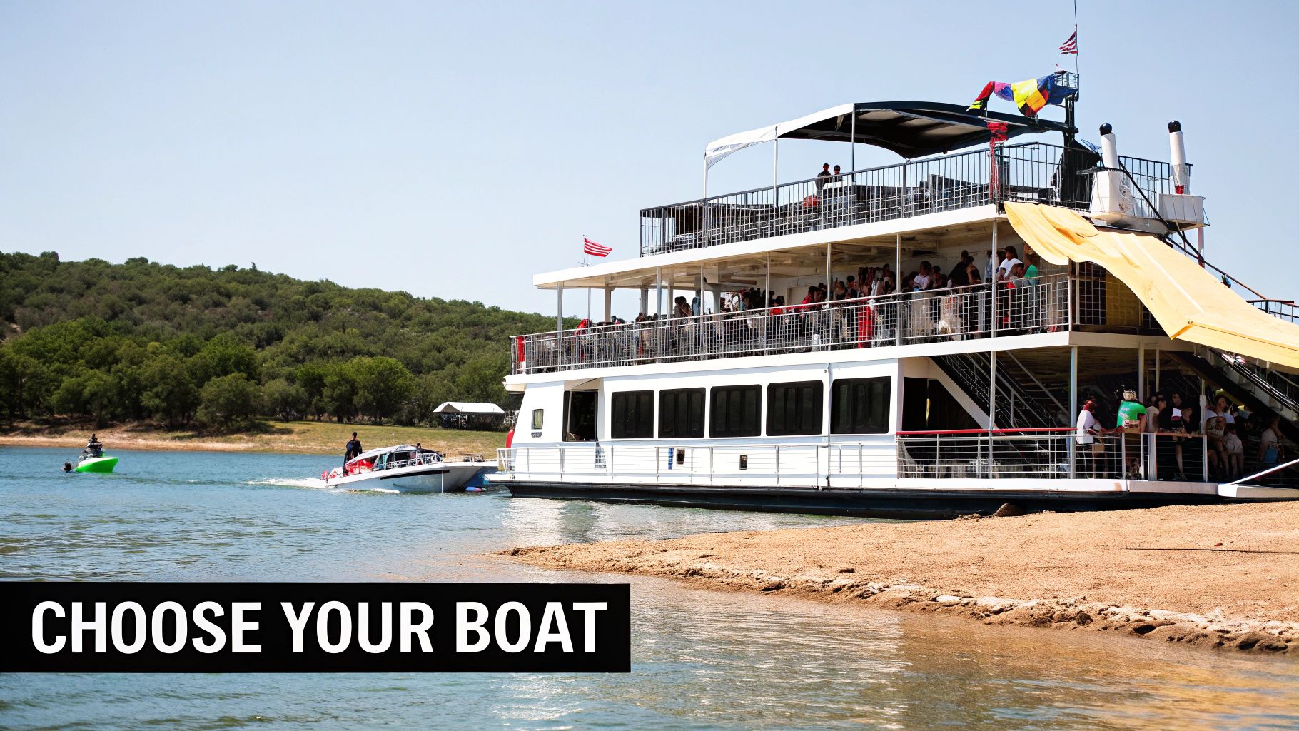 A large multi-deck party boat filled with people docked on a lake, with smaller boats nearby.
