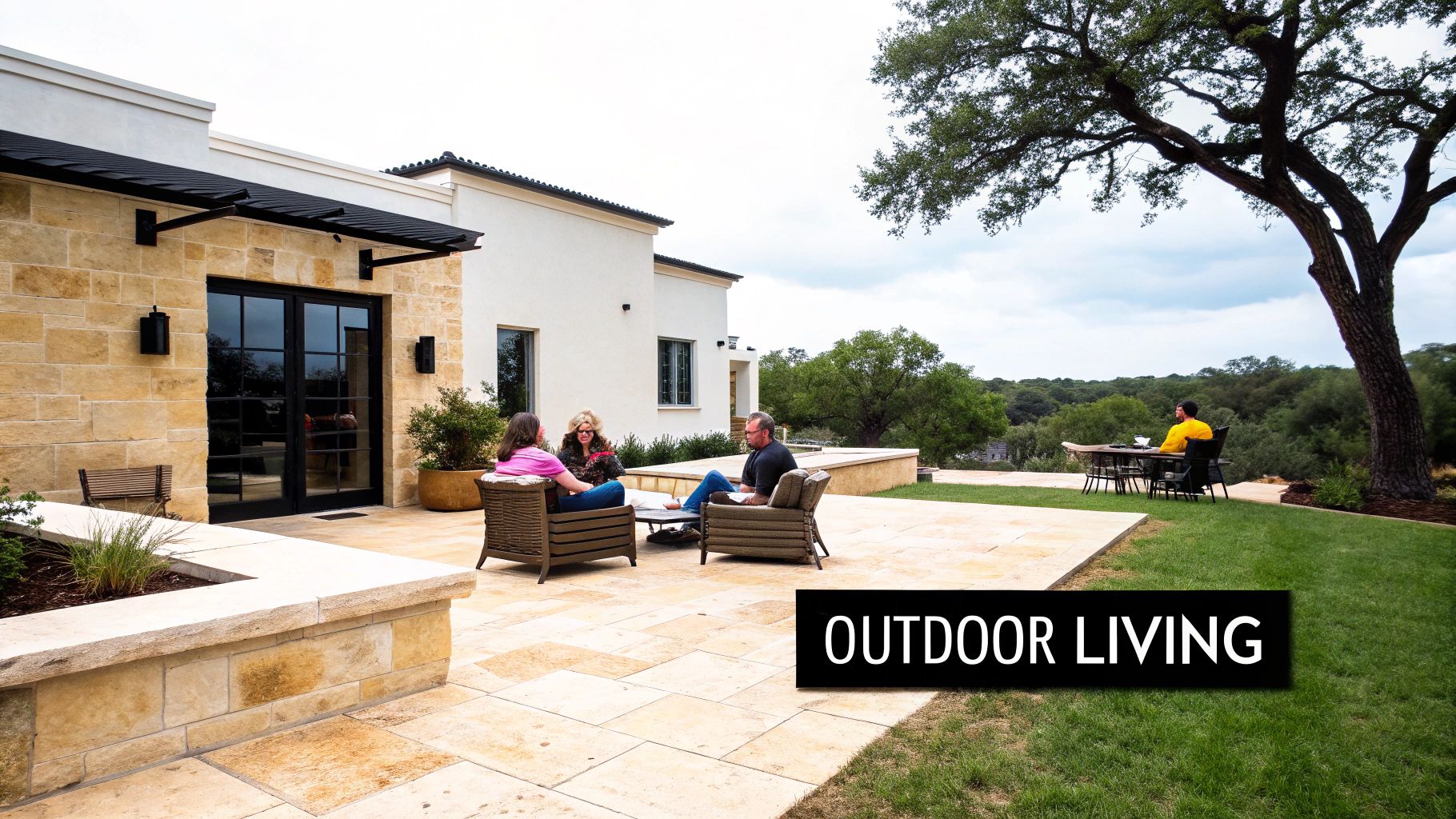 A spacious outdoor living area with a stone patio, comfortable seating, and a scenic natural view.