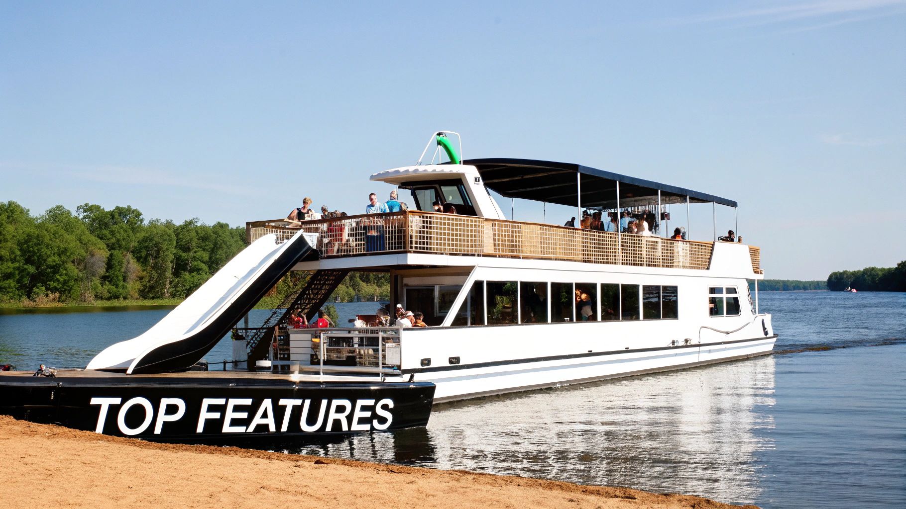 People enjoy a sunny day on a large double-deck boat with an attached water slide on a calm lake.