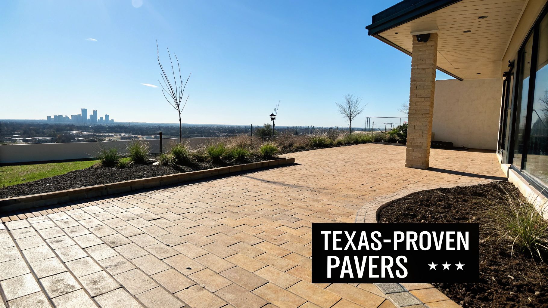 An expansive outdoor patio paved with light brown brick pavers offers a panoramic city skyline view.