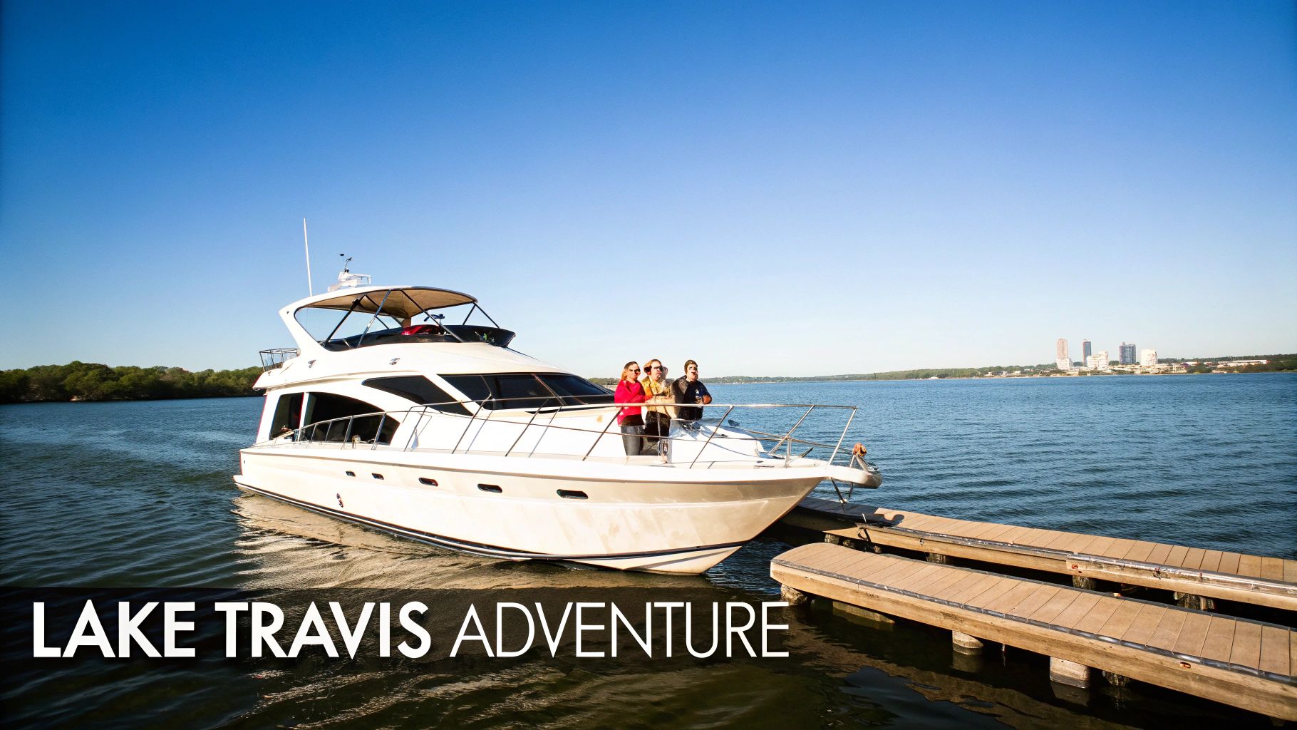 A white yacht with three people docked at a pier on Lake Travis under a clear blue sky.