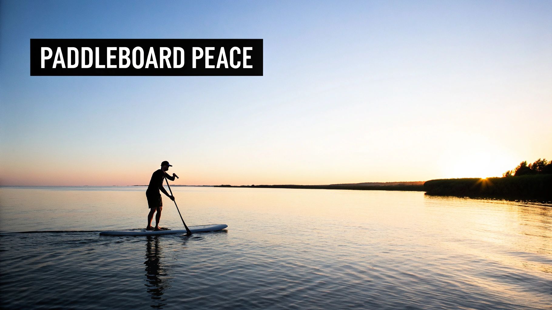 A person paddleboards on calm water during a beautiful sunset, finding peace and tranquility.