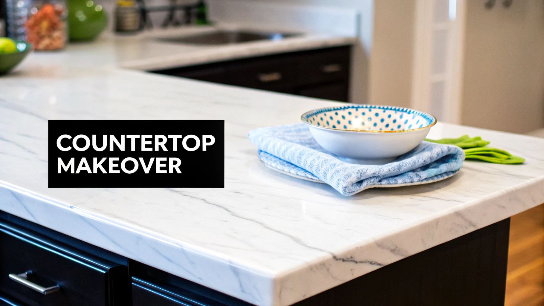 Close-up of a modern kitchen island with a white marble countertop, featuring a decorative bowl and towel.