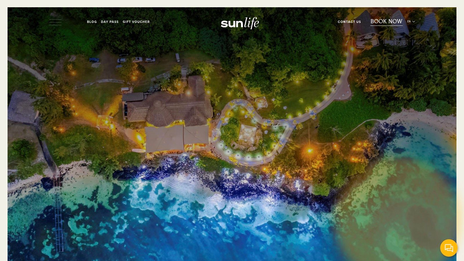 A lush tropical resort in Mauritius with palm trees, a swimming pool, and the ocean in the background.