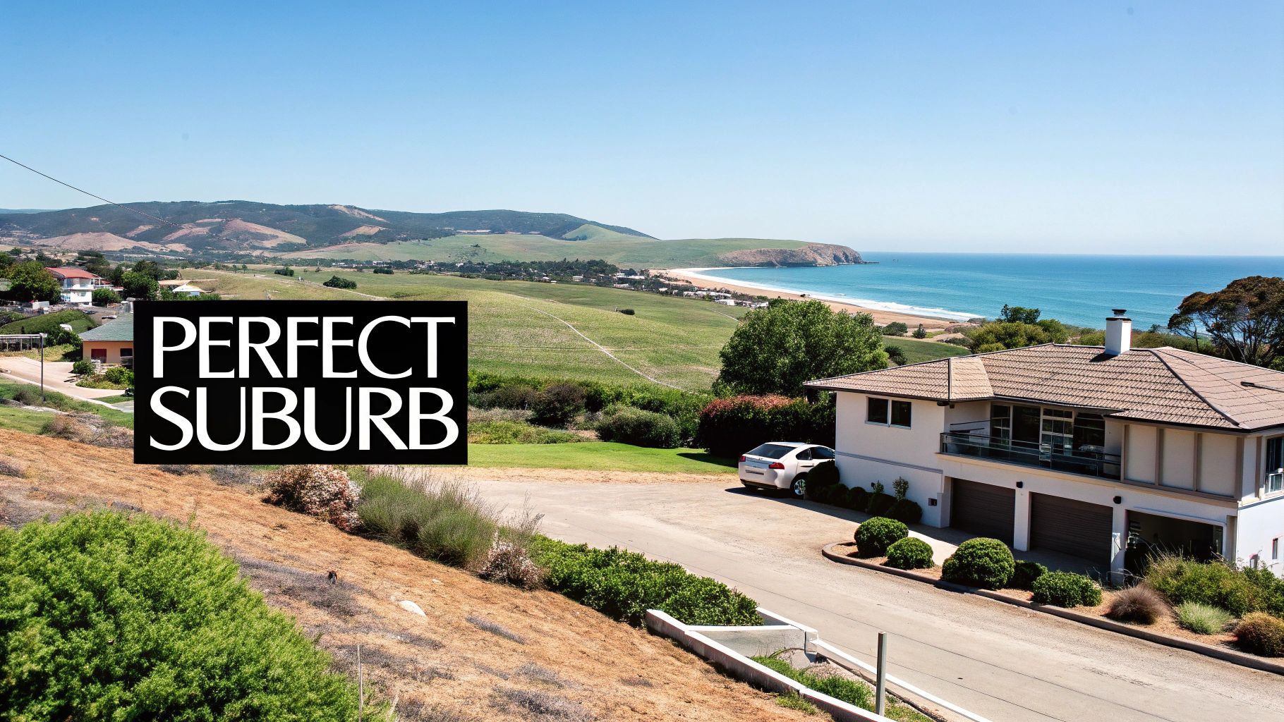 Scenic view of a large house overlooking a stunning beach and ocean under a sunny sky.