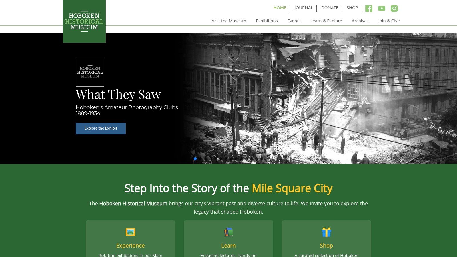 An old, black-and-white photograph displayed at the Hoboken Historical Museum, showing a historic street scene.