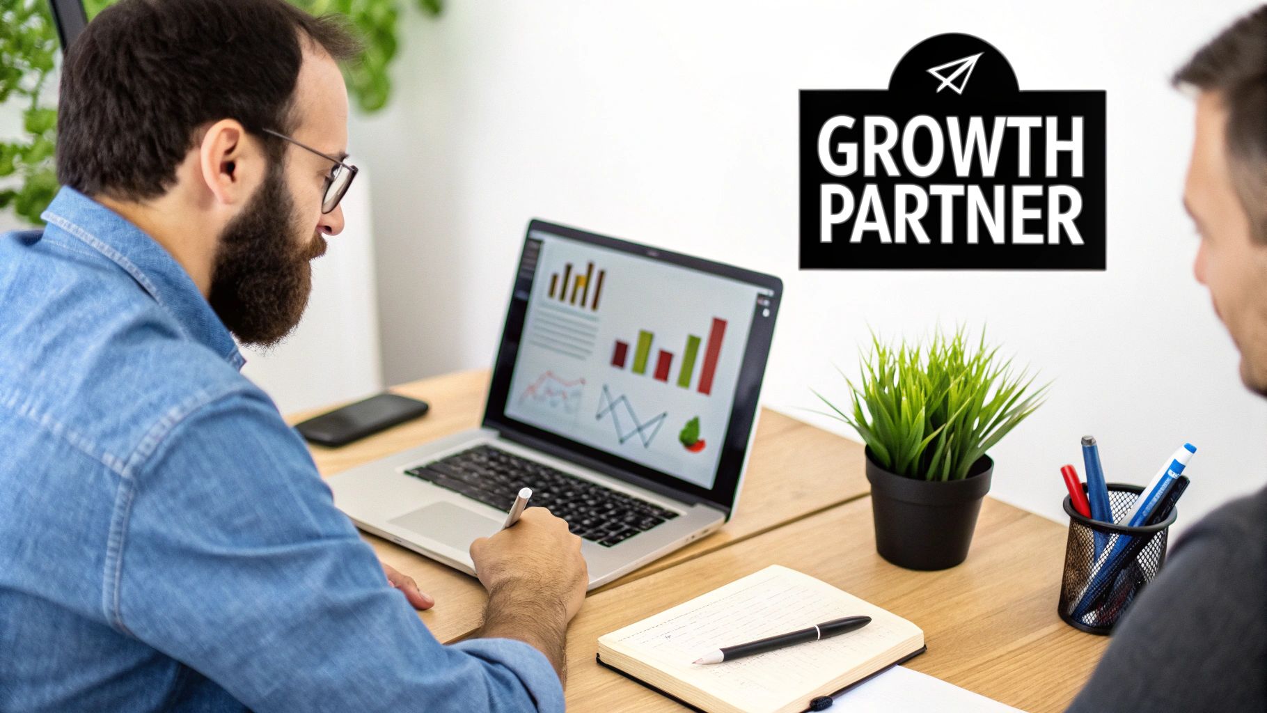 Two men collaborating on business growth strategies, viewing charts and graphs on a laptop.