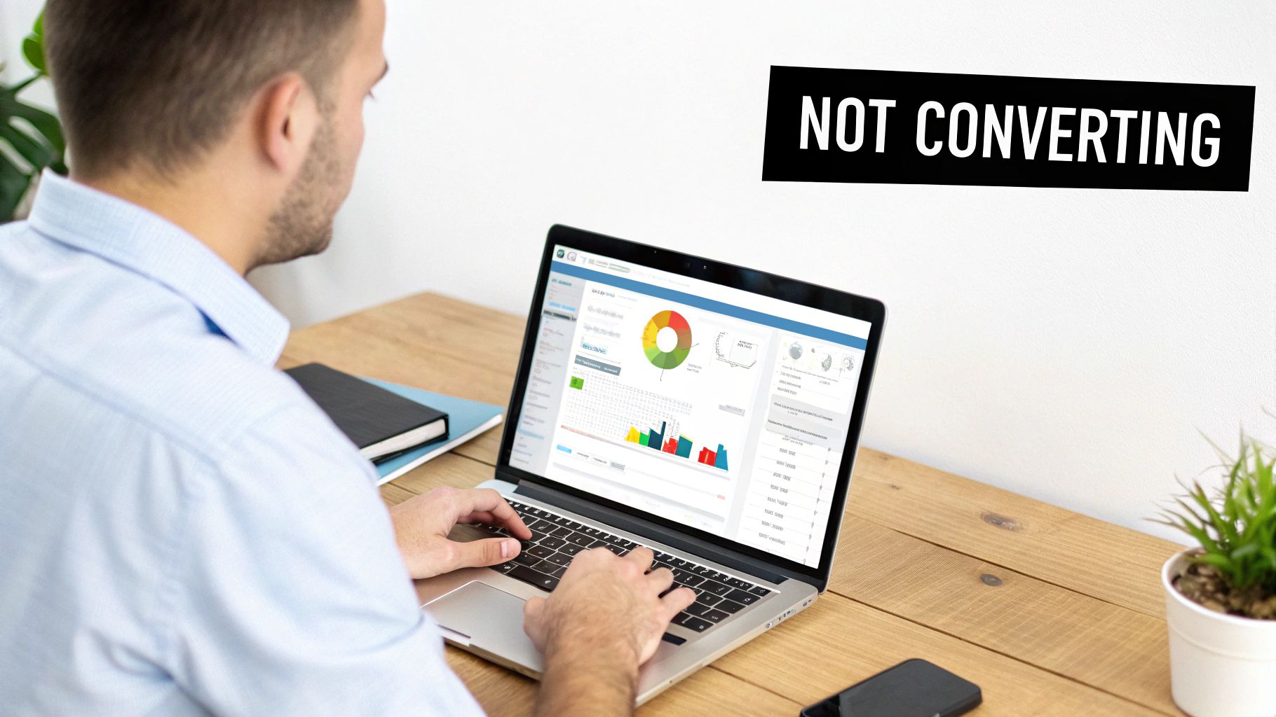 Man viewing a laptop with a data dashboard showing charts and 'NOT CONVERTING' overlay.