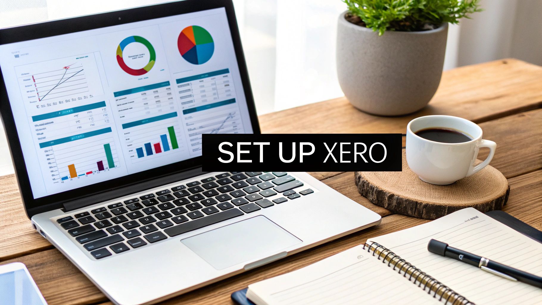 A desk setup with a laptop displaying financial charts, a cup of coffee, and a notebook.