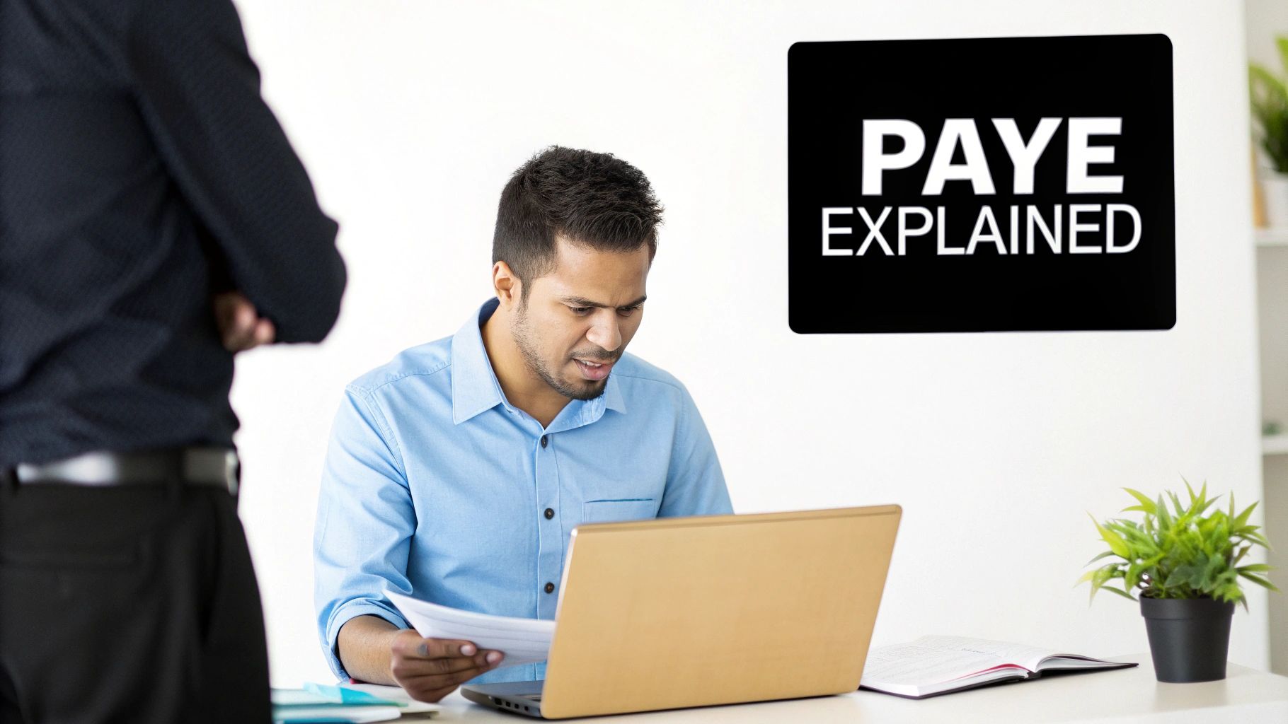 Business professional reviewing PAYE tax documents at desk with laptop and explanatory presentation