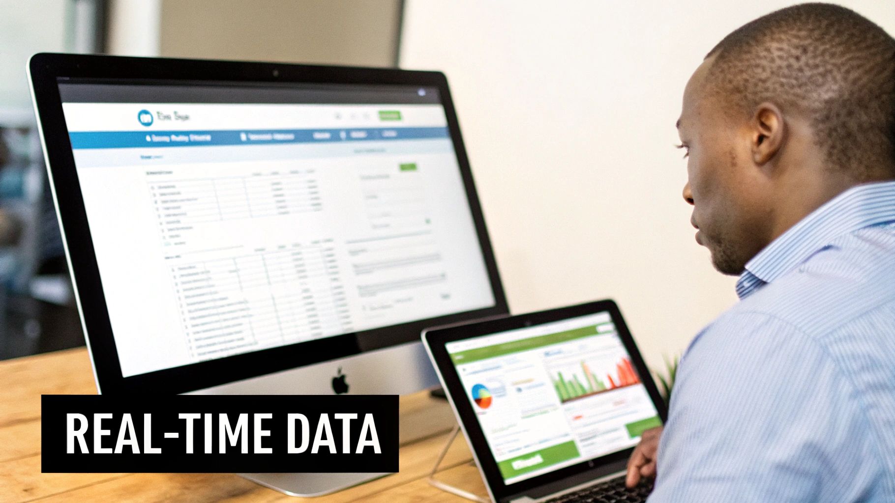 A man uses two computer screens displaying data dashboards and management tools, focusing on real-time data.