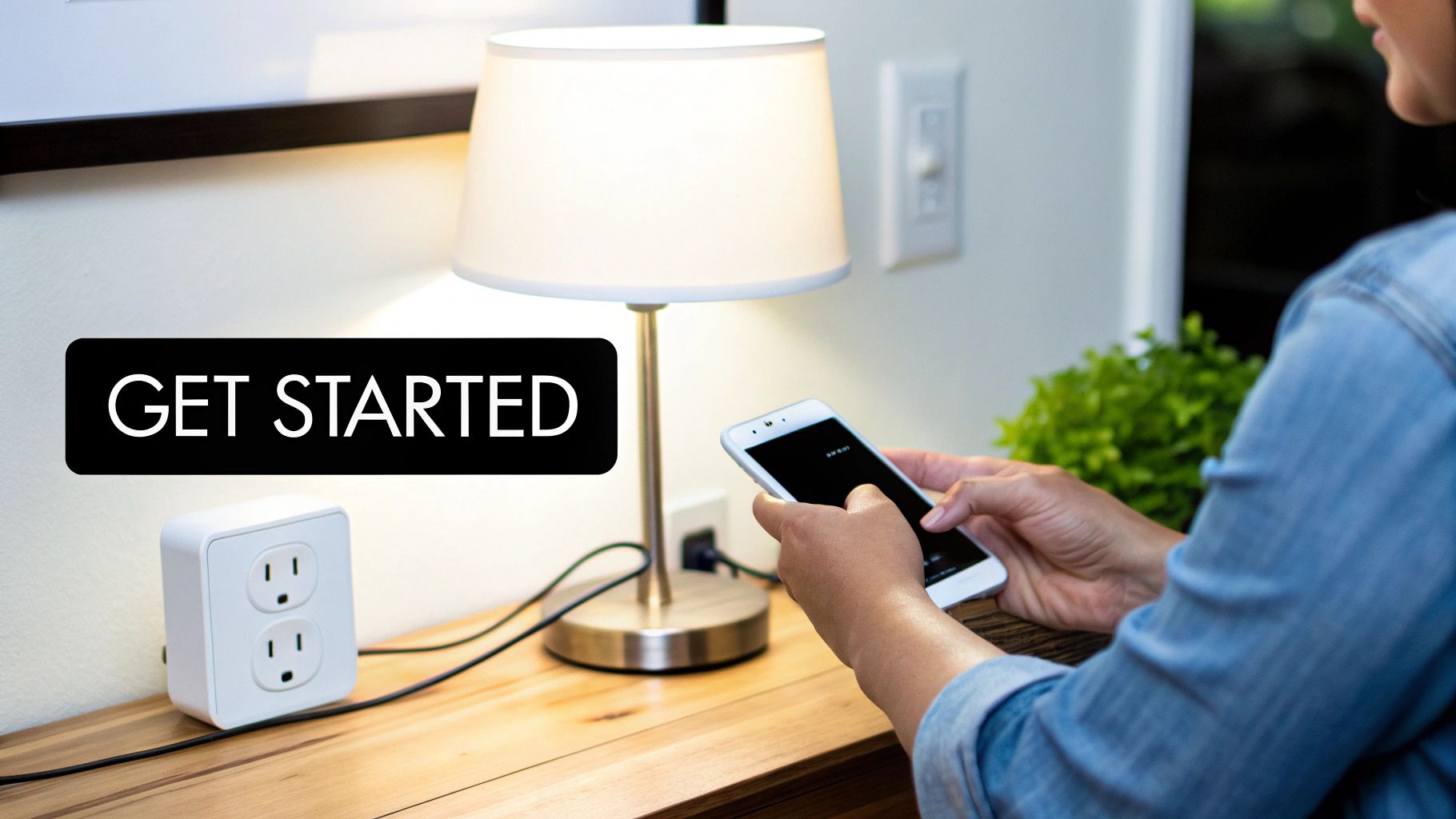 Person using a smartphone to set up a smart plug connected to a lamp.