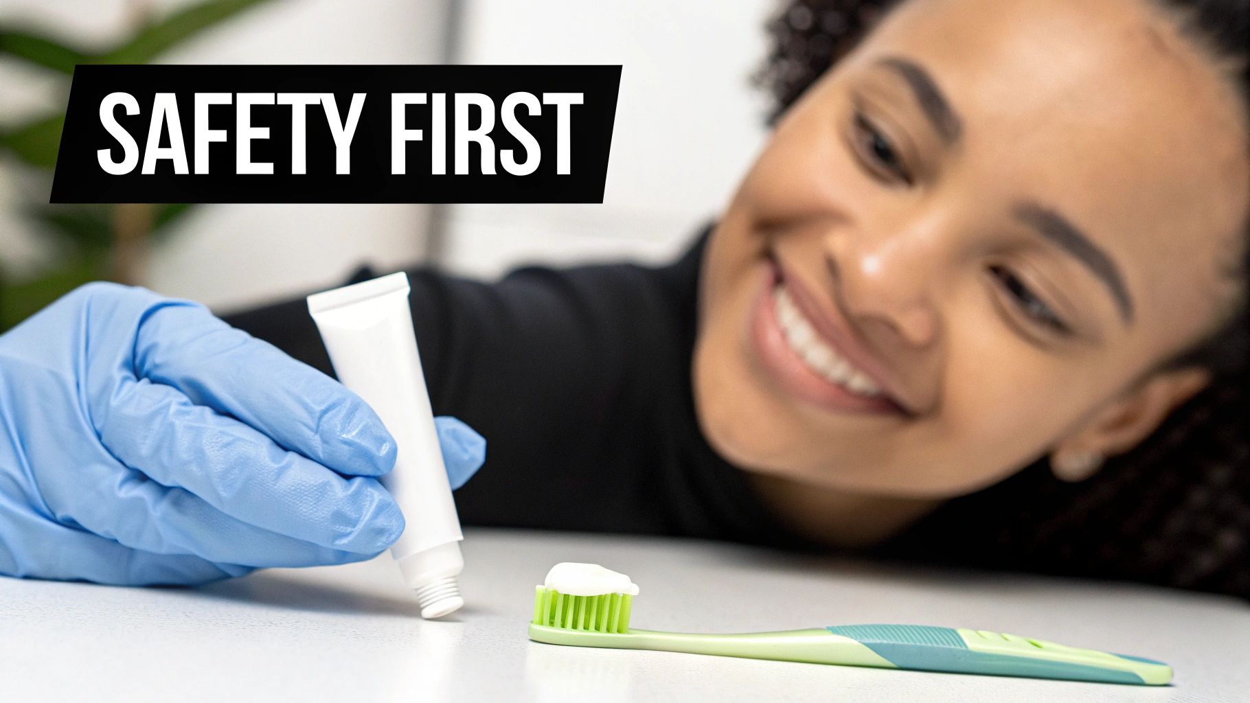 A person in blue gloves squeezes toothpaste onto a green toothbrush, with a smiling face and 'SAFETY FIRST' text.