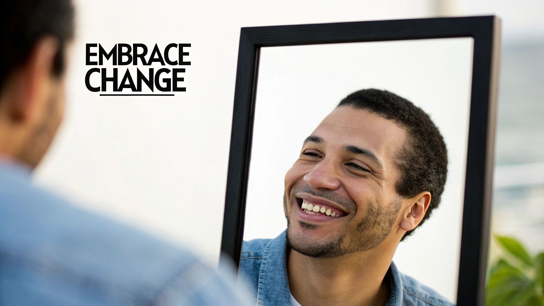 A man is shaving his head in front of the mirror.