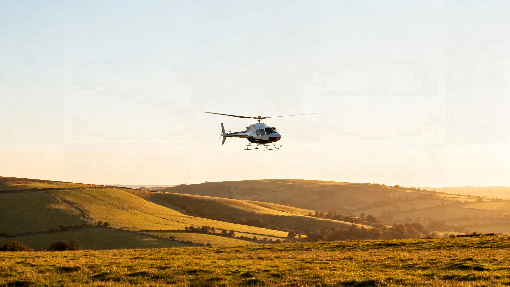 A scenic aerial view of a UK landscape from a helicopter cockpit