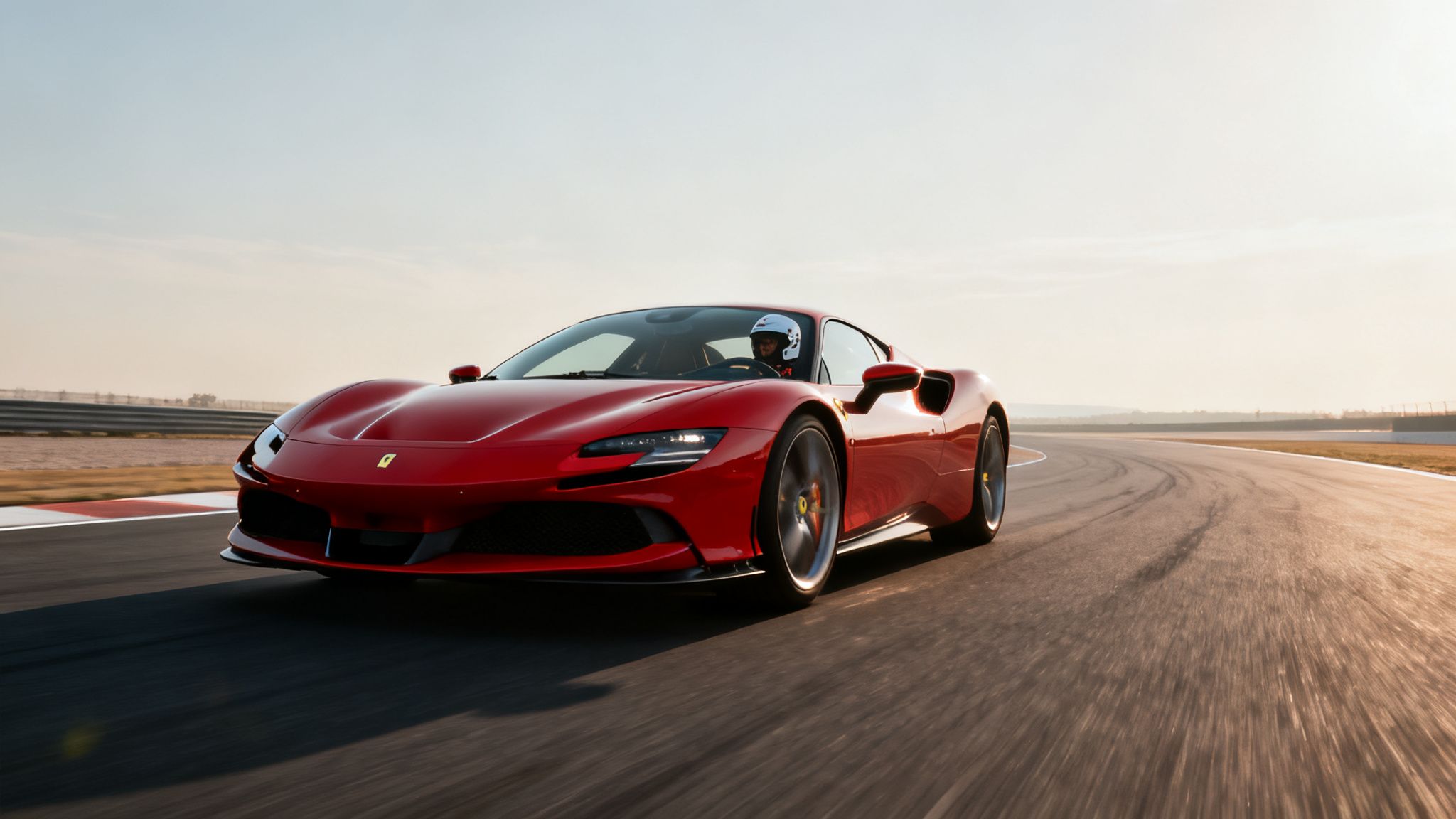 A vibrant red Ferrari supercar with a driver on a race track during a sunny day.