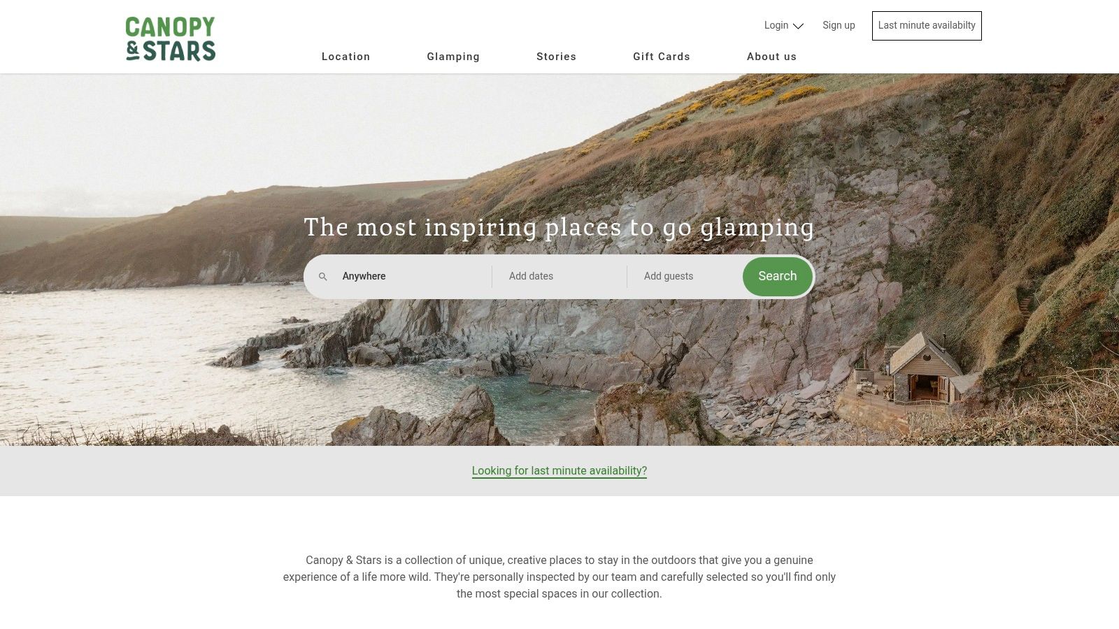 A glamping pod with a wooden hot tub overlooks a stunning UK coastal scene at sunset.