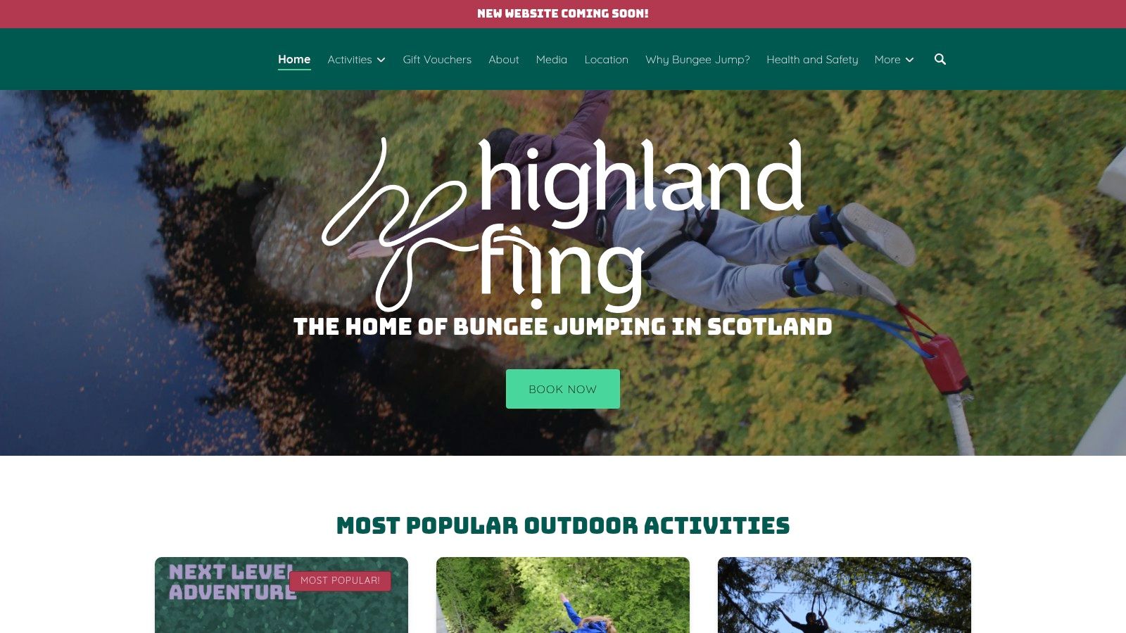 A person bungee jumping from a bridge over a lush, green gorge.