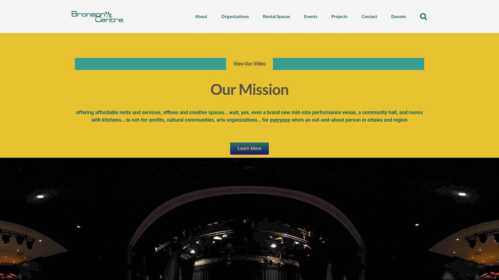 A view from the stage at the Bronson Centre Music Theatre, looking out at the seats and balcony.