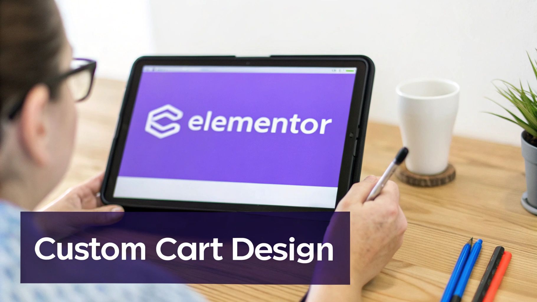 Person using Elementor software on tablet for custom cart design on wooden desk
