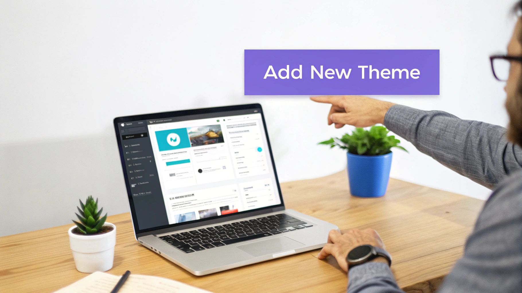 A person points to a laptop displaying a website dashboard, with an 'Add New Theme' banner.