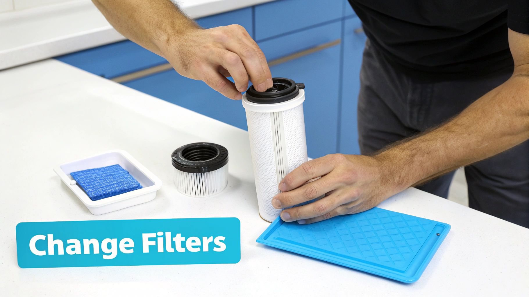 A person's hands are changing white cylindrical water filters on a clean white kitchen counter.