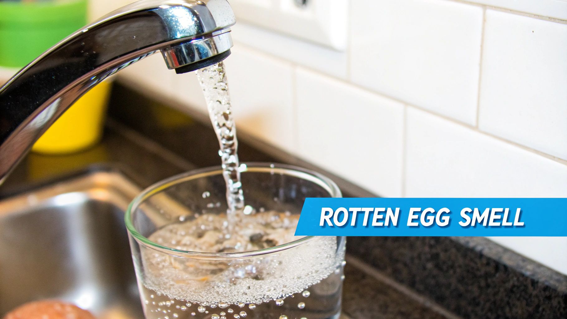 Chrome faucet filling glass with water that has rotten egg sulfur smell odor