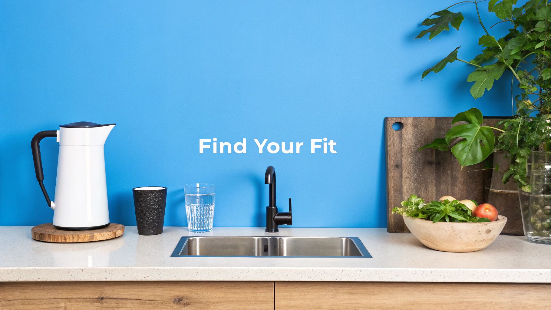 A person's hands holding a glass of clear water under a modern kitchen faucet.
