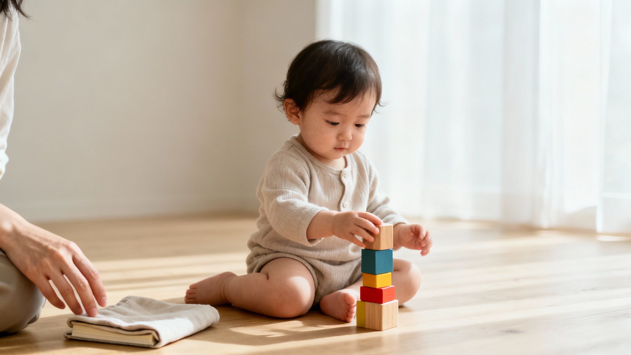A cute toddler sits on the floor, focused on stacking vibrant educational wooden blocks.