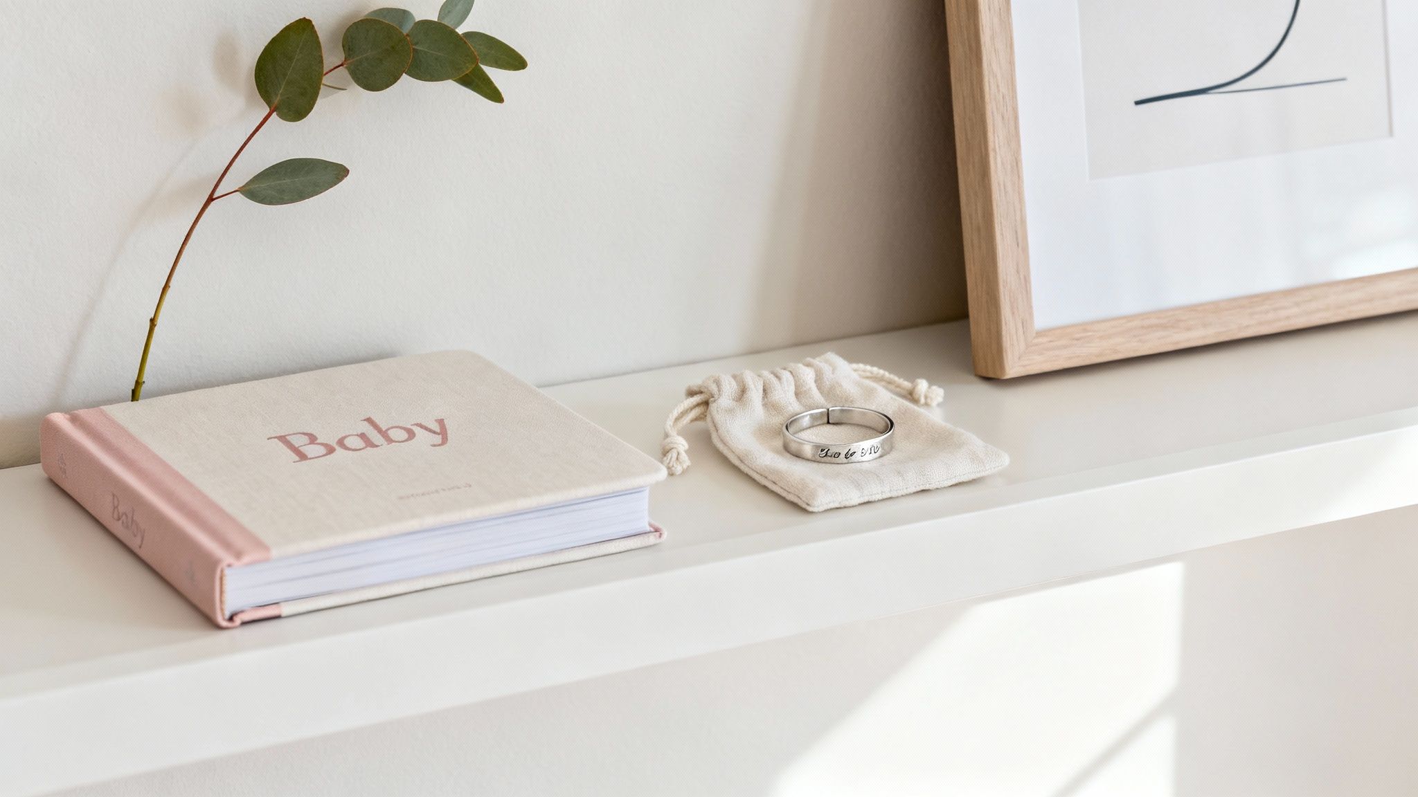 A personalised baby blanket draped over a cot.