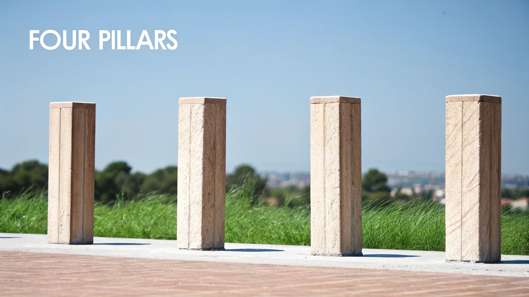 Four light-colored stone pillars stand on a paved path, with green grass and a blue sky. Four light-colored stone pillars stand on a paved path, with green grass and a blue sky.