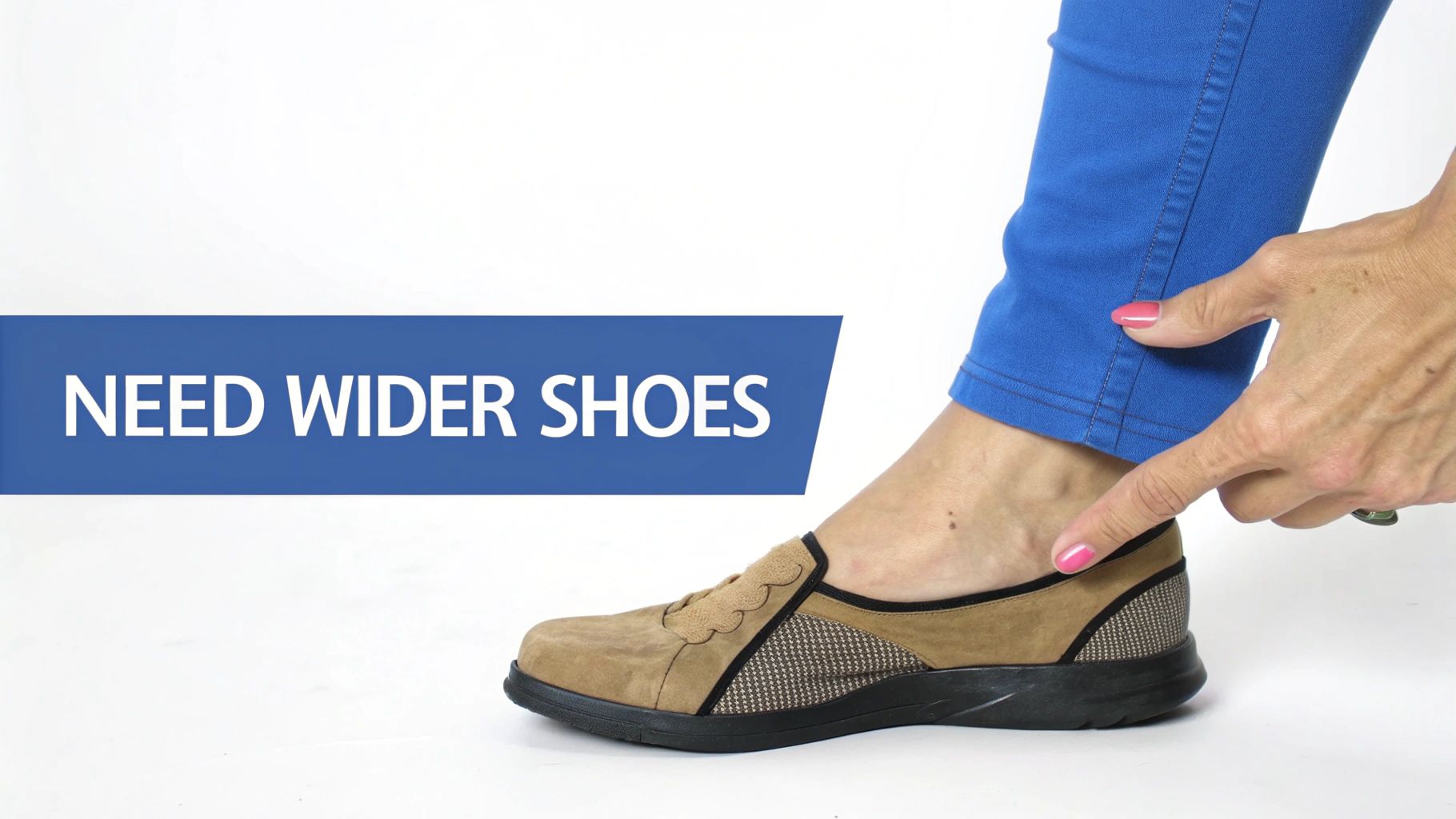 A person's foot in a wide, comfortable brown shoe, with a hand pointing to the ankle. Banner says 'NEED WIDER SHOES'.