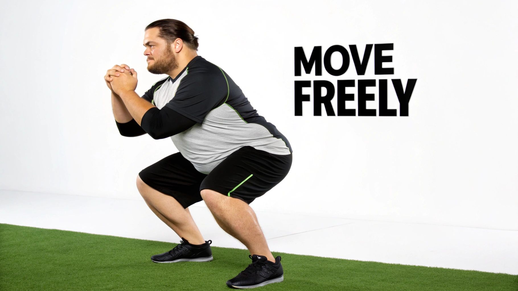 A larger man performs a squat on green turf, wearing black and grey athletic gear. "MOVE FREELY" is visible in the background.